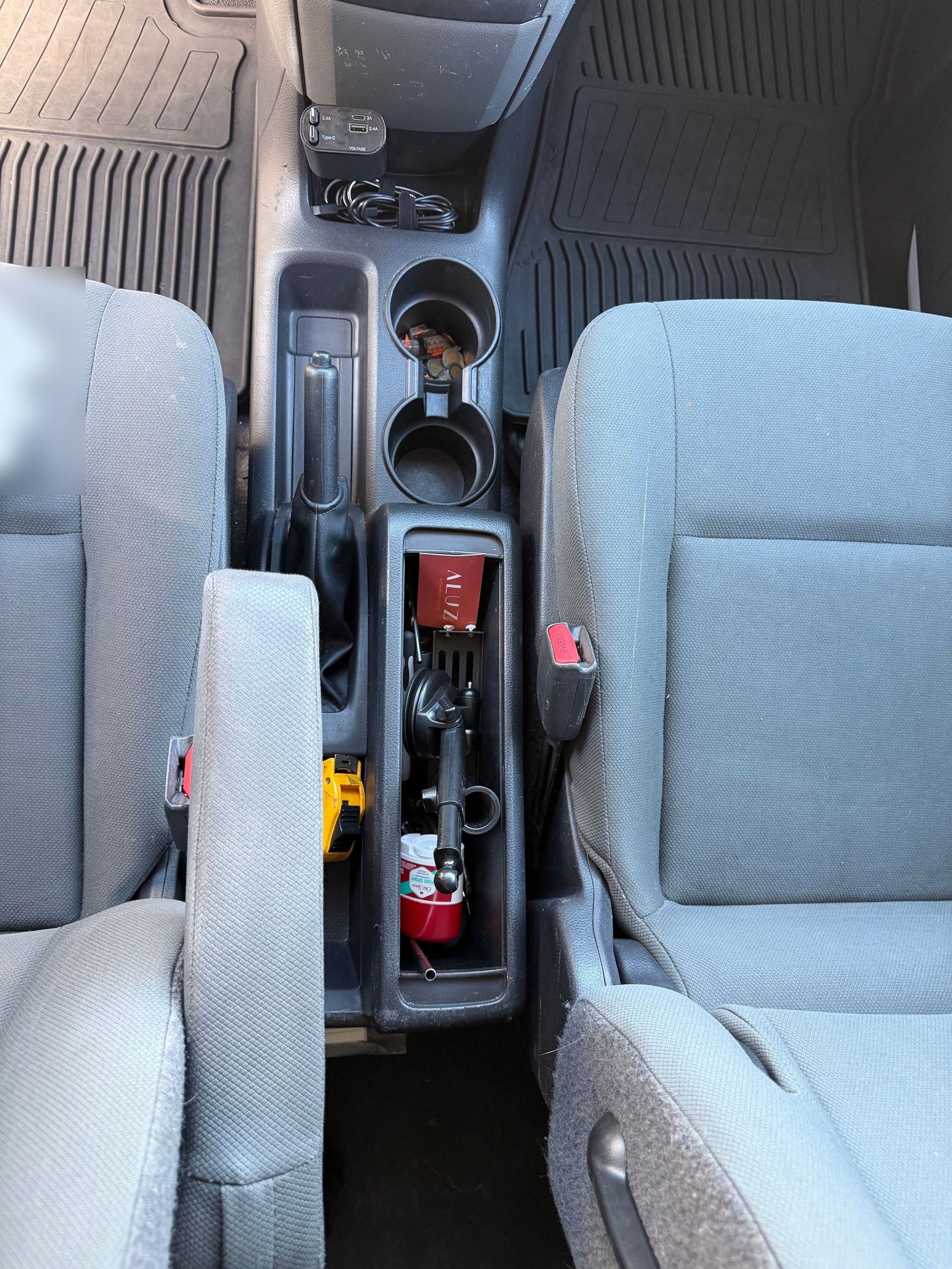 Clean, organized front seats and center console of a Nissan NV200 after detailing